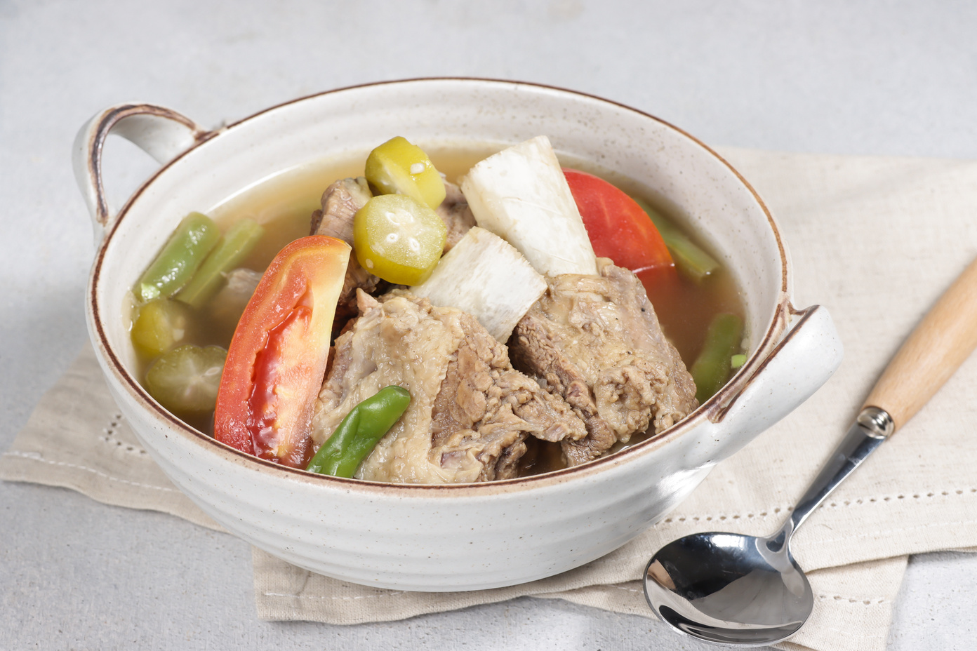 Asem-asem daging iga sapi or beef rib soup with sweet and sour taste, a typical dish of East Java, Indonesia.